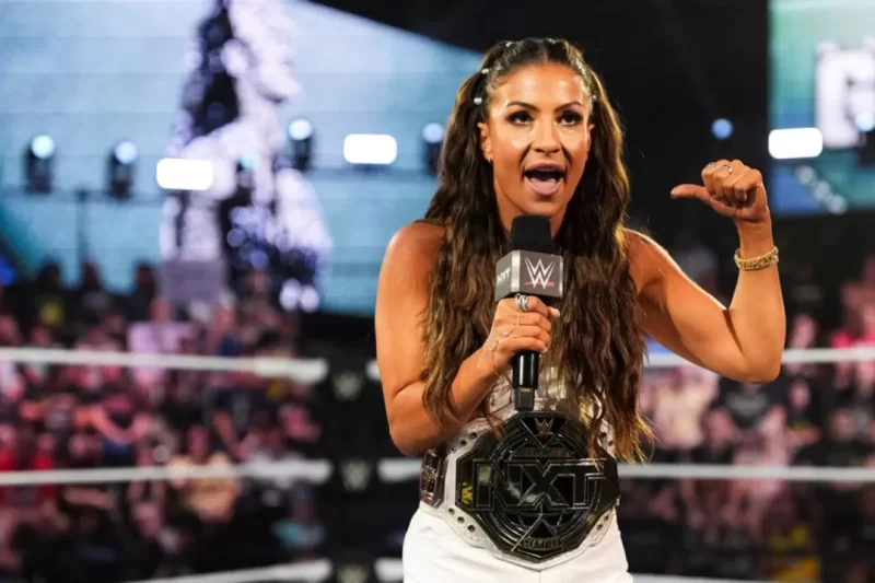 NXT Women's Champion Kendal Grey celebrating her victory in the ring, potentially hinting at a future call-up to WWE Raw or SmackDown.