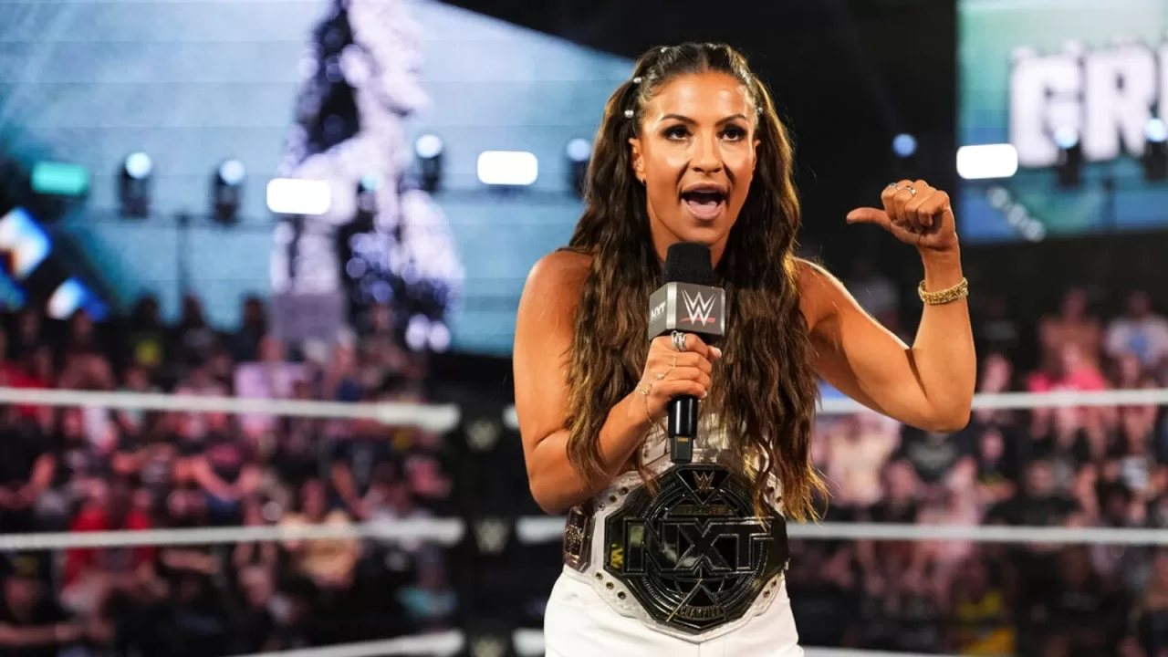 NXT Women's Champion Kendal Grey celebrating her victory in the ring, potentially hinting at a future call-up to WWE Raw or SmackDown.